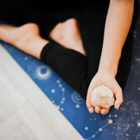 Person doing Yoga Holding a Crystal