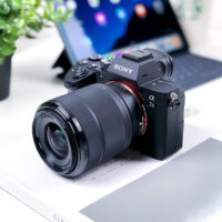 Digital Camera Next to Laptop