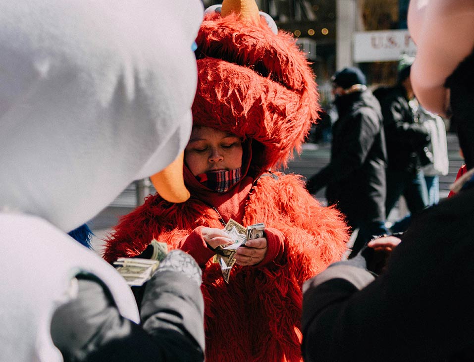 People in Costumes Counting Money